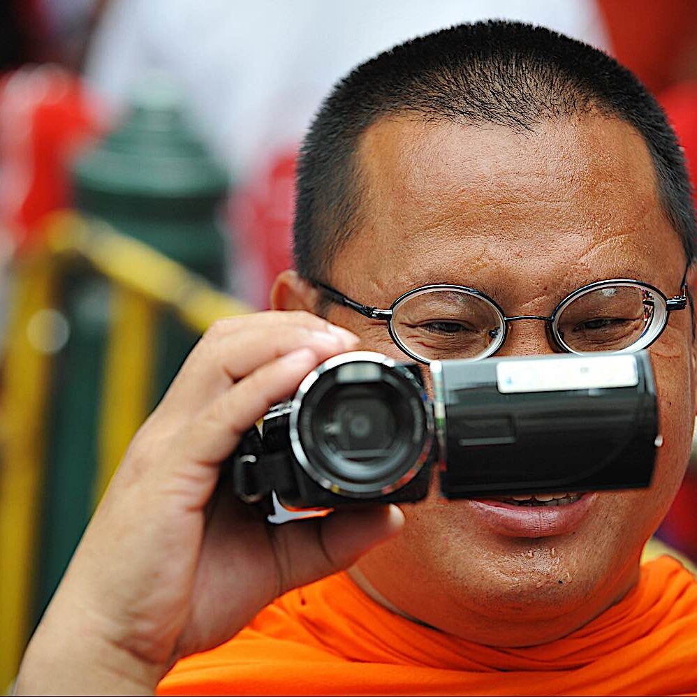 Buddha-Weekly-Buddhist monk with camcorder dreamstime_l_49495638-Buddhism Buddha-Weekly-Buddhist monk with camcorder dreamstime_l_49495638-Buddhism
