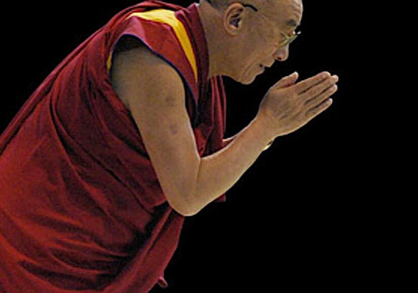 The Dalai Lama bows.
