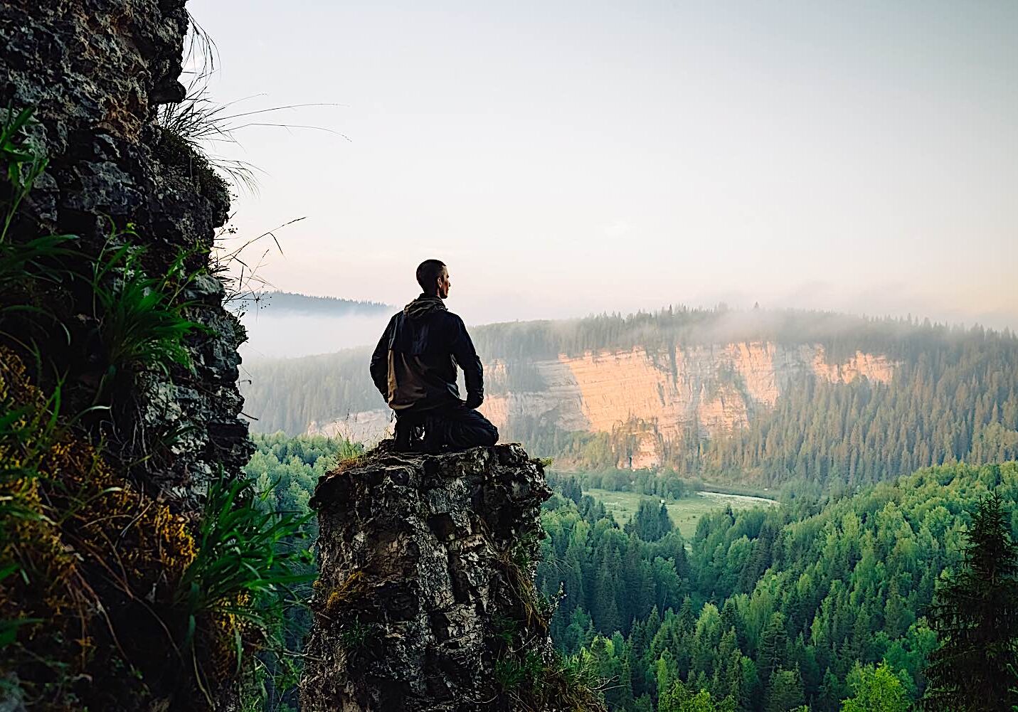 Buddha-Weekly-Man on top of rock meditation dreamstime_l_73662835-Buddhism A man meditates in nature. Meditaiton has 10 recognized health benefits based on research.