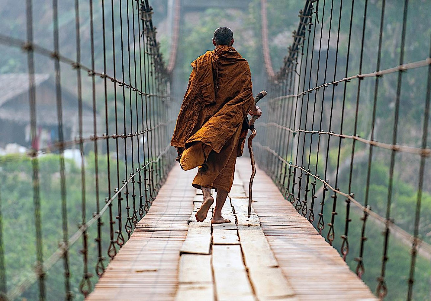Buddha-Weekly-monkl walking suspension bridge in Mae Hong Son dreamstime_l_168411703-Buddhism A Theravadan monk crossing a suspension bridge in mae Hong Son.