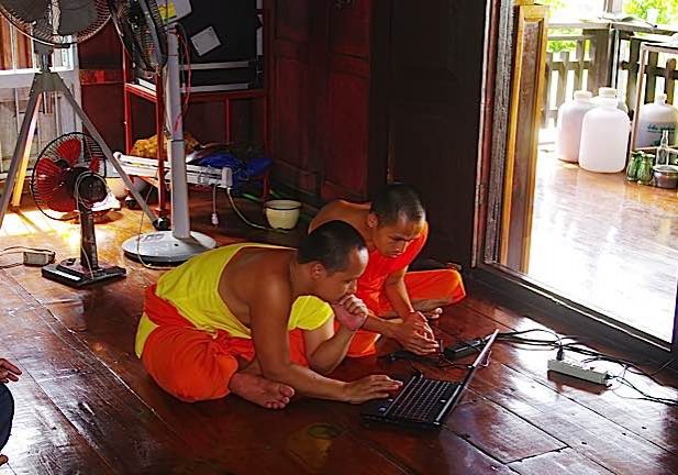 Buddha-Weekly-Monks in Thailand on computer dreamstime_m_20907177-Buddhism Buddhist monks in Thailand using a computer on the floor of the temple. Computers, mobile phones and tablets are common today in temples and monasteries.