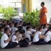 A monk teaching school children at Wat Temple Saraburi Thailand.